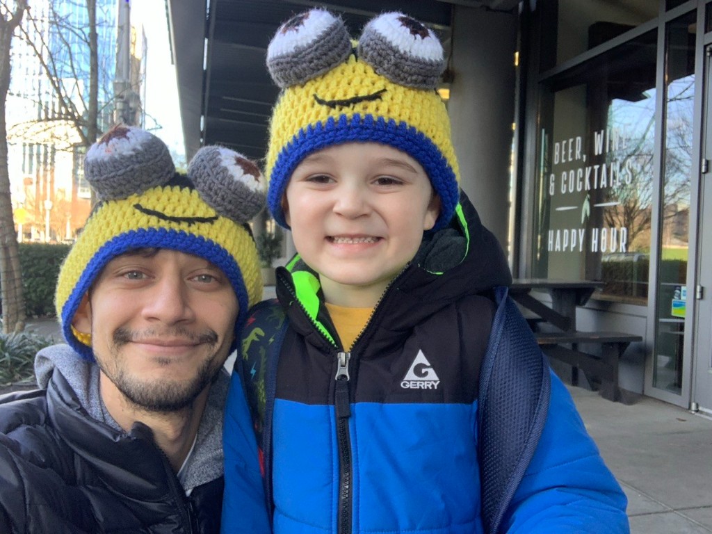 Aziz with his father wearing matching playful hats