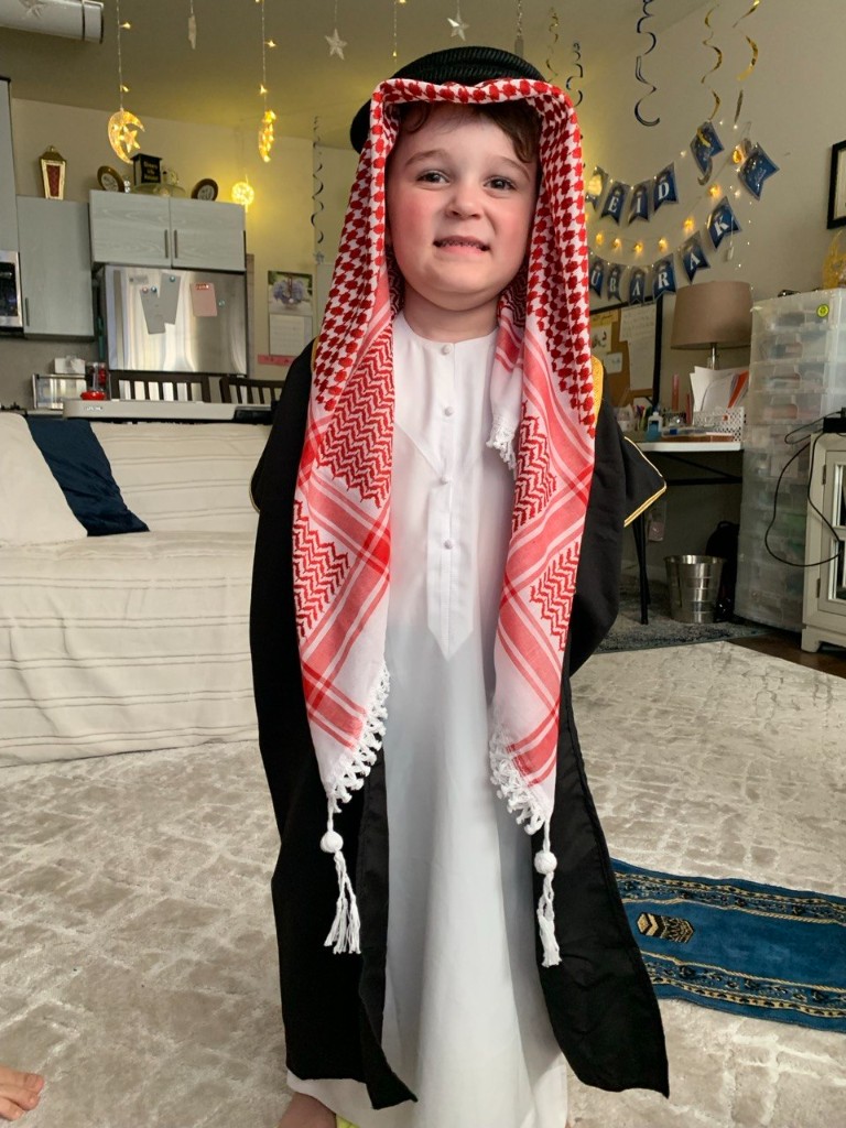 Aziz dressed in traditional Arabic attire celebrating Eid